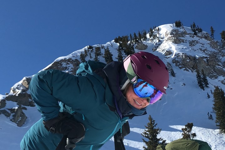 a man flying through the air on a snow covered mountain